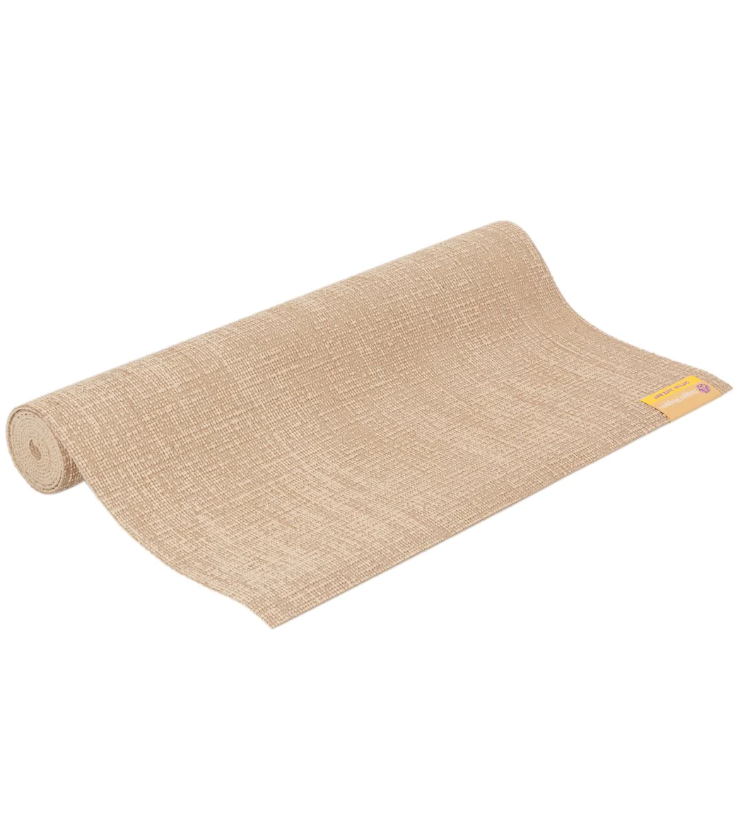 A rolled up tan jute yoga mat from Hugger Mugger