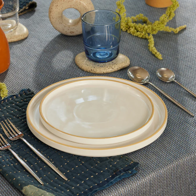 Table setting with cream-colored ceramic plates from Our Place