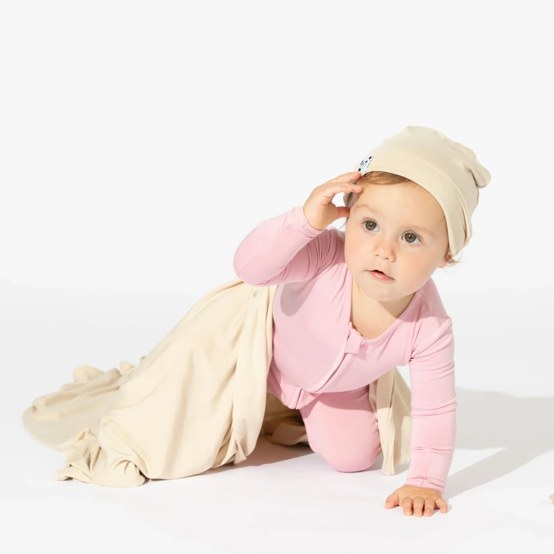 A baby wearing pink bamboo convertible footie pajamas from Bellabu Bear