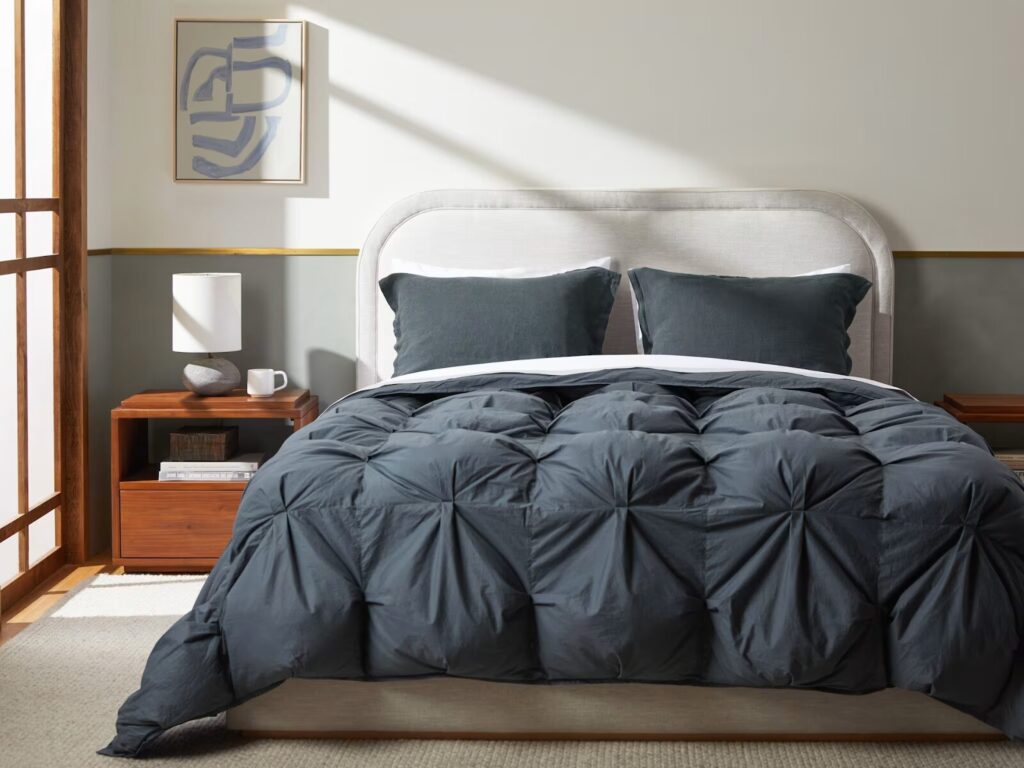 A charcoal OEKO-TEX comforter from Parachute on a bed