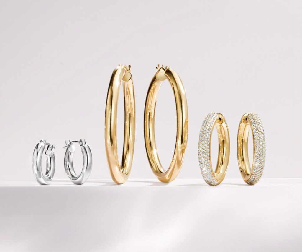 Three pairs of silver, gold, and diamond hoop earrings