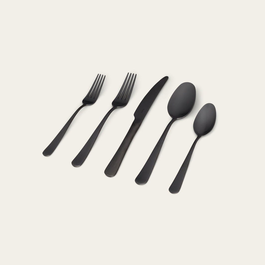 Modern matte black flatware set: forks, knife, and spoons.