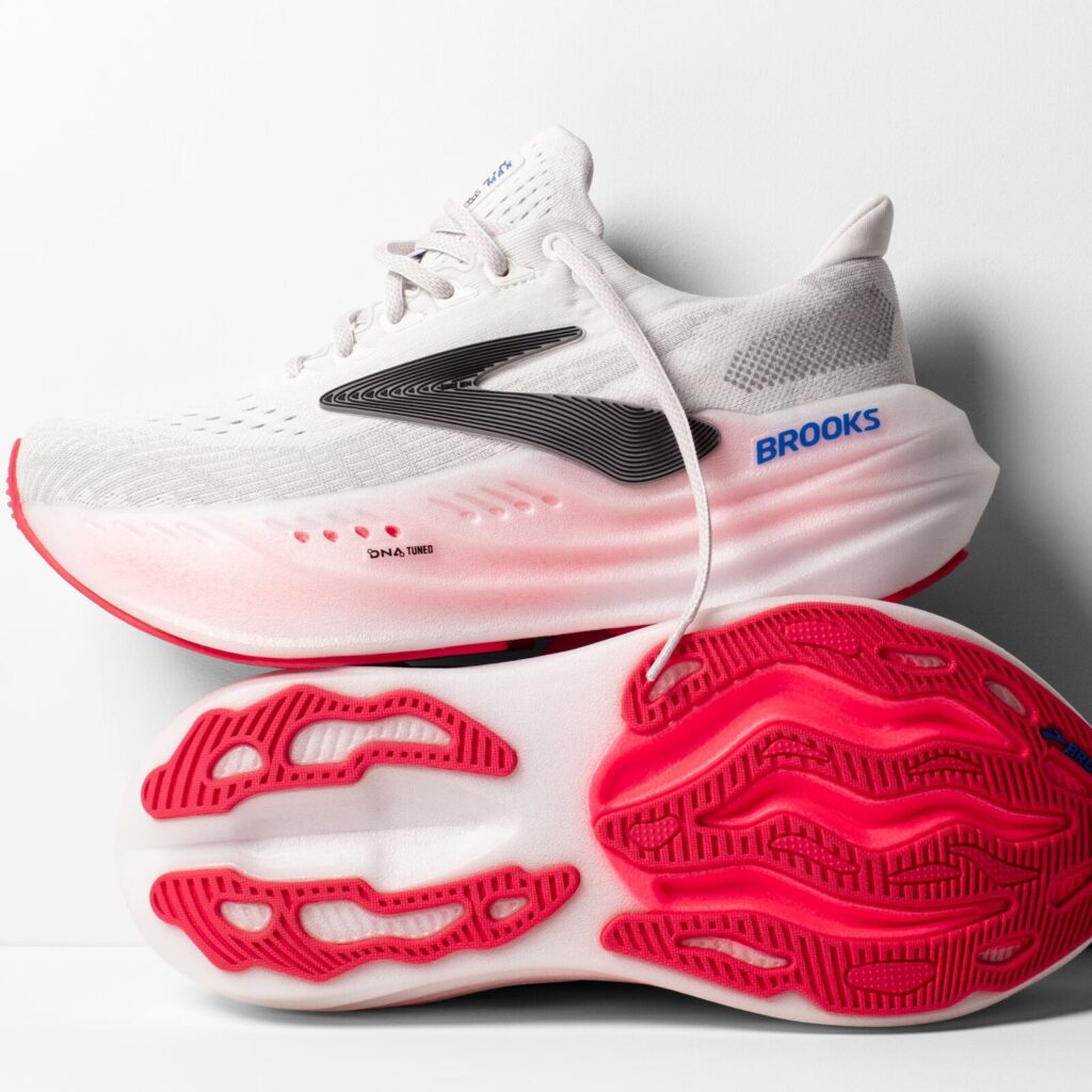 A pair of hot pink and white vegan running shoes from the brand Brooks.